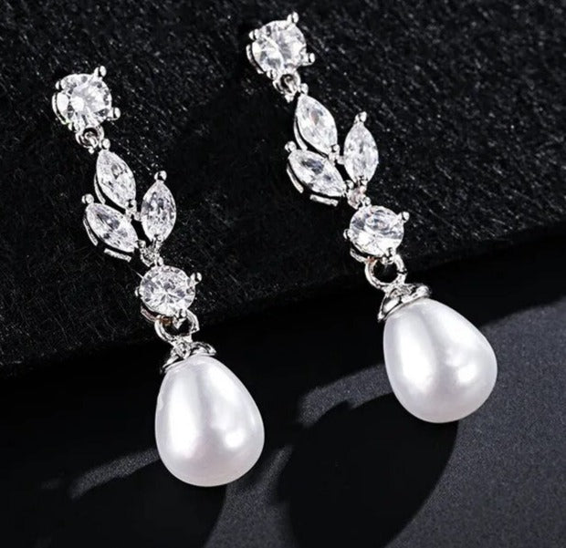 White Color: Comes in 3 colors. These elegant Fashion Marquise Cut Cubic Zircon Earrings feature simulated pearl and leaf-style marquise dangle, making them perfect for a special occasion. With a brilliant cubic zirconia design, these earrings combine classic elegance with modern glamour and are sure to be a favorite accessory